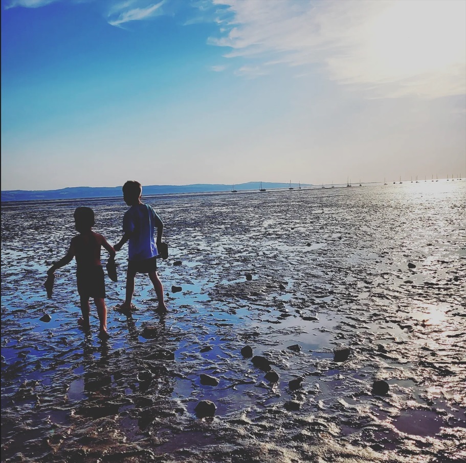 Brothers walking along the beach at Thurstaston