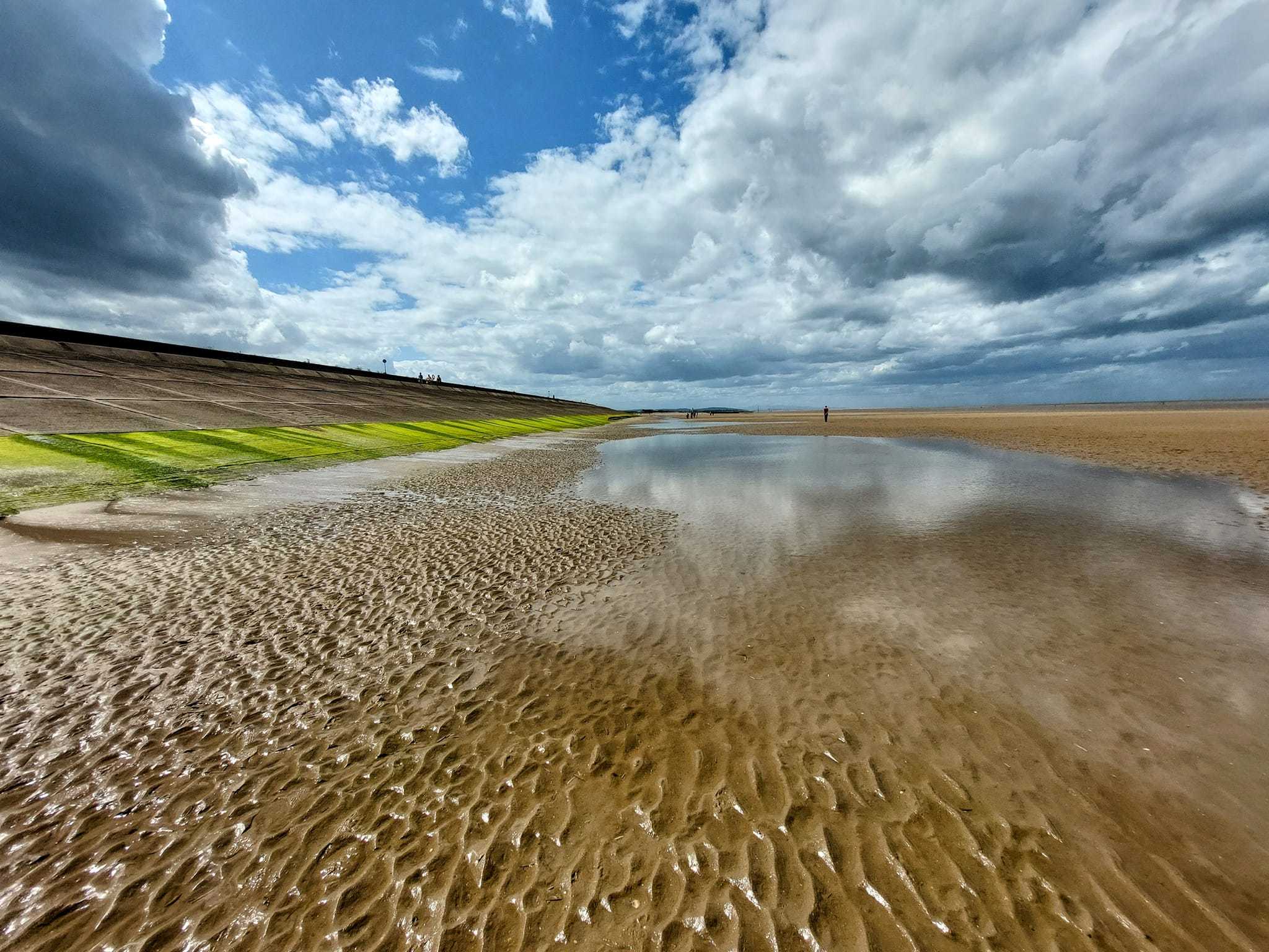 In the distance in Leasowe Bay by Julie Longshaw