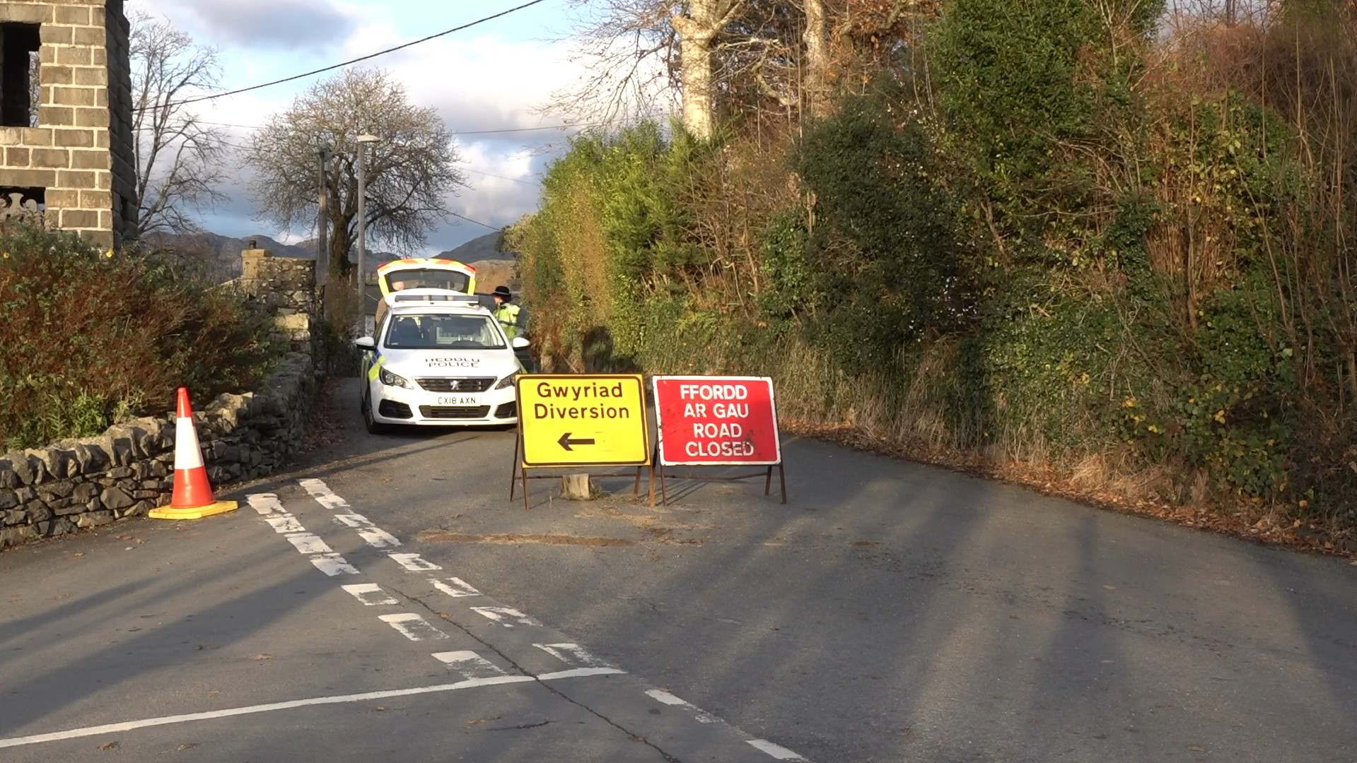 Police close the road near the scene where the teenagers were found. Image PA