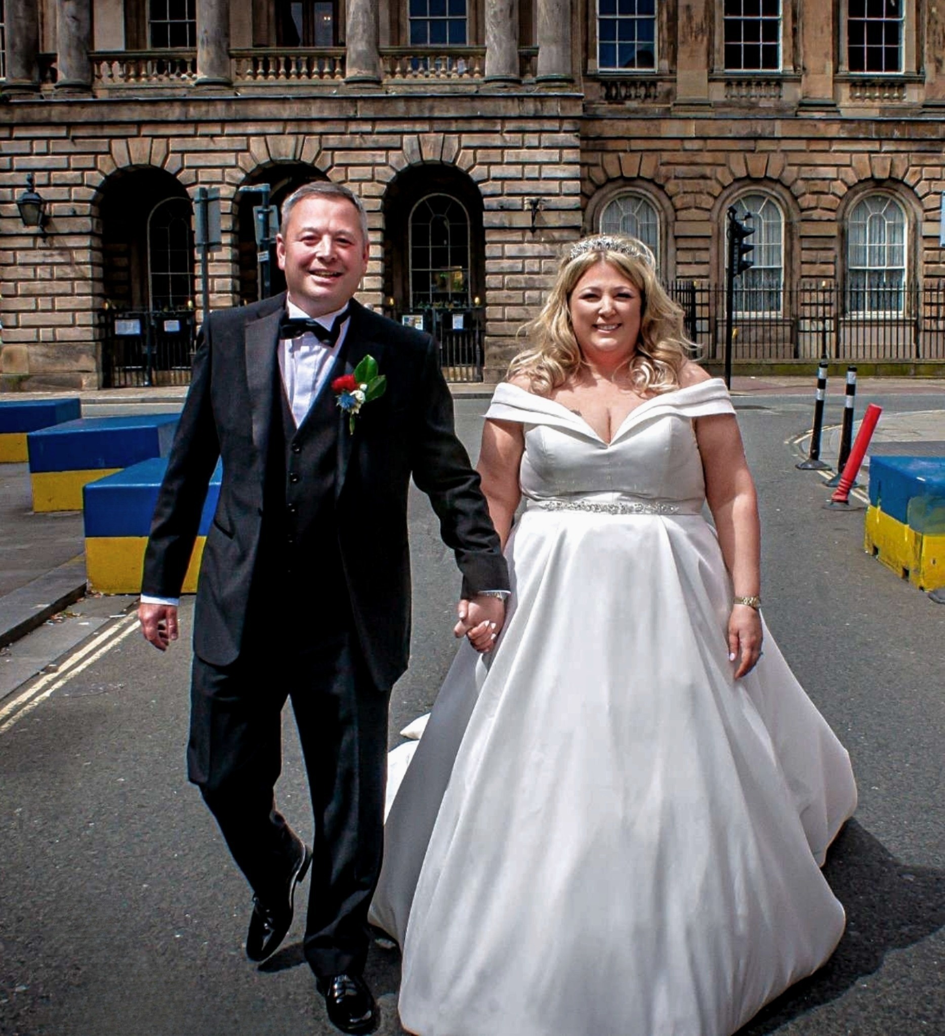 Shoppers clapped and cheered as the happy couple walked through the city centre